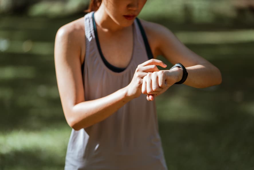 A woman checking her fitness tracker watch