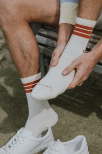 Athlete holding their foot in a white sock