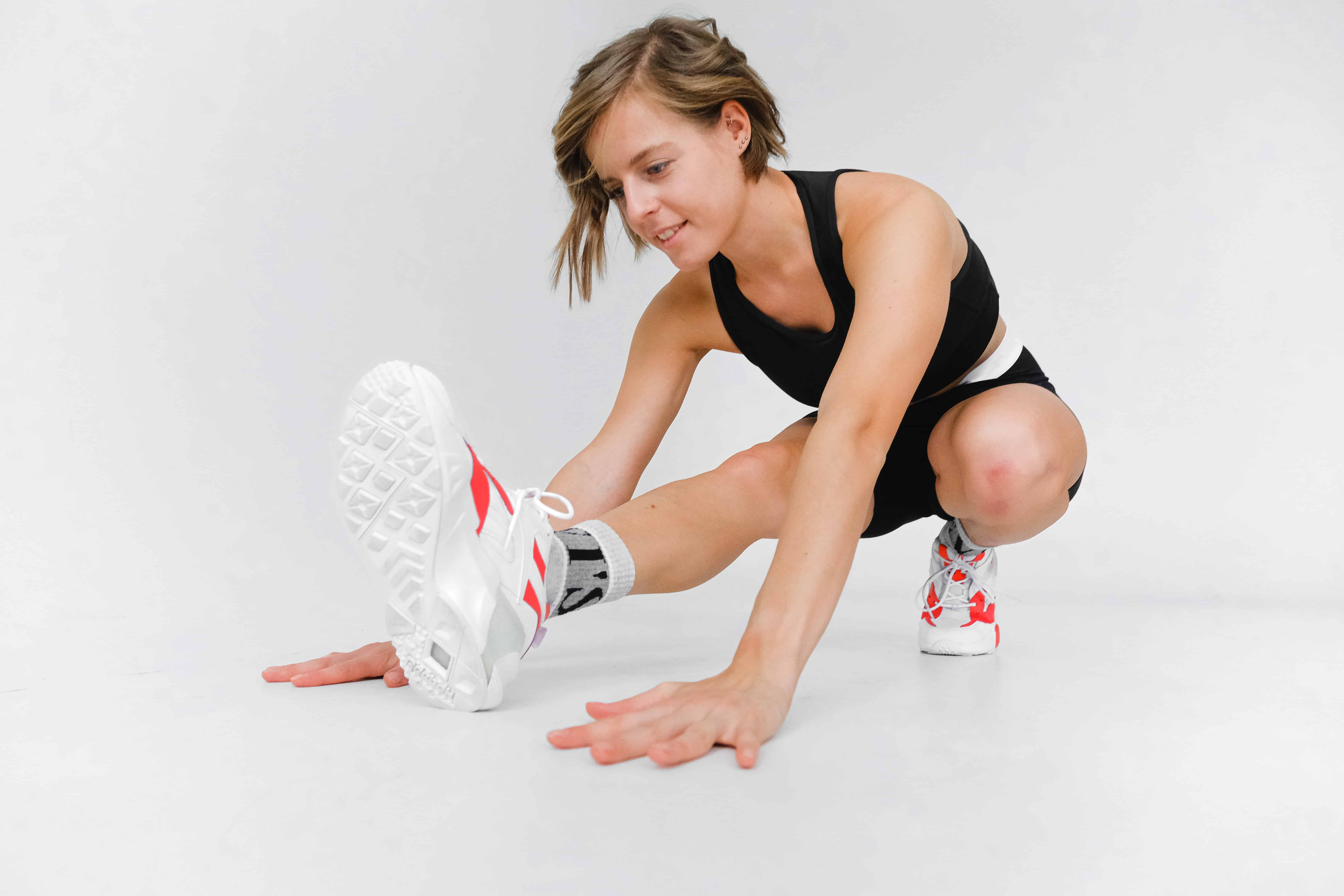 A woman performing leg stretching