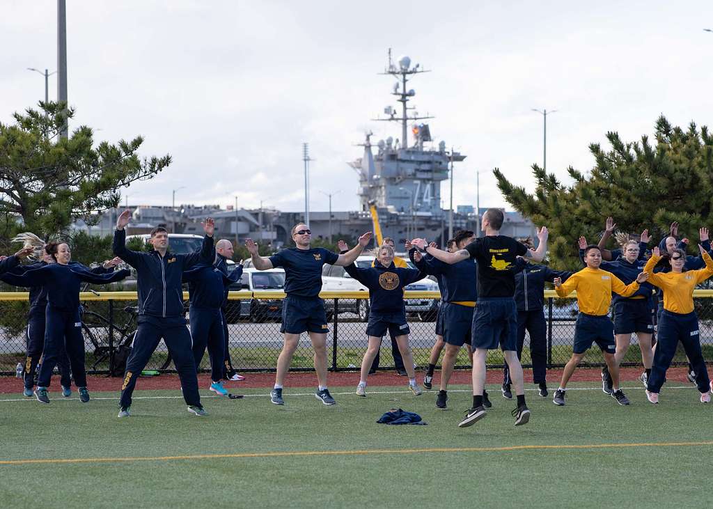 Soldiers doing jumping jacks outdoors