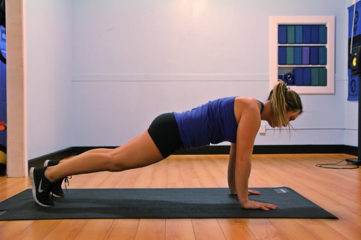 A woman doing planks at home