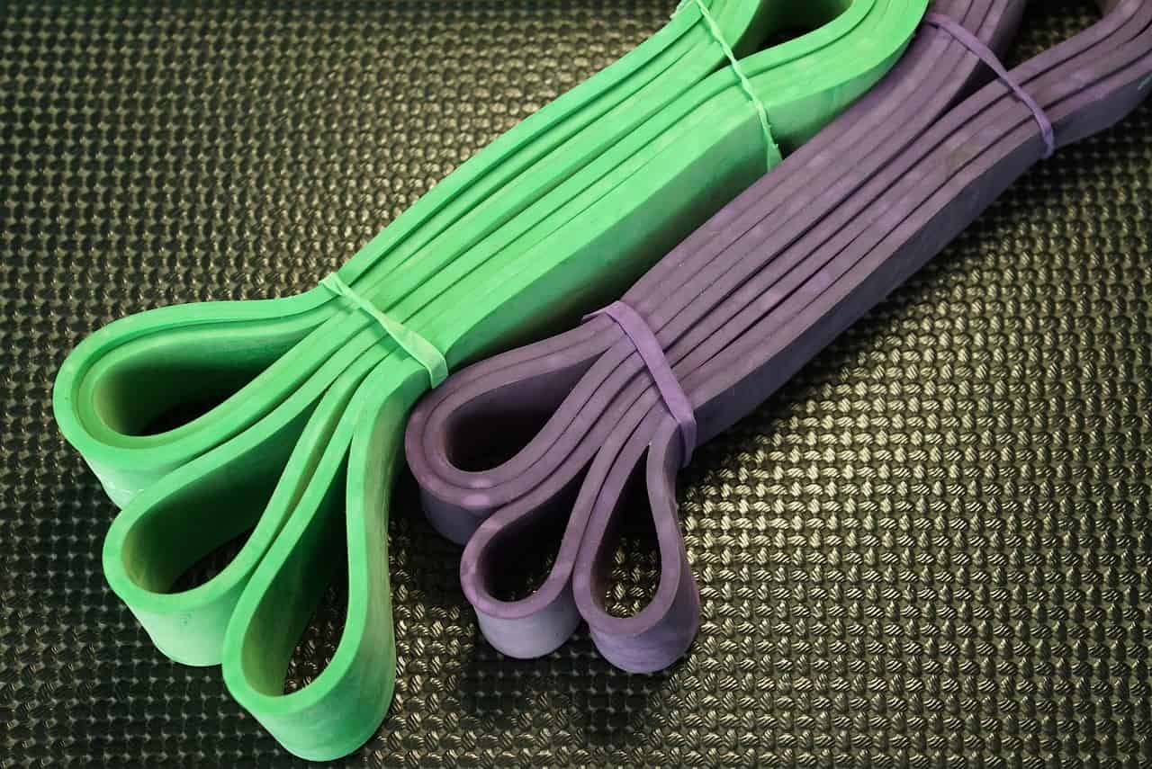 A set of resistance bands in green and violet