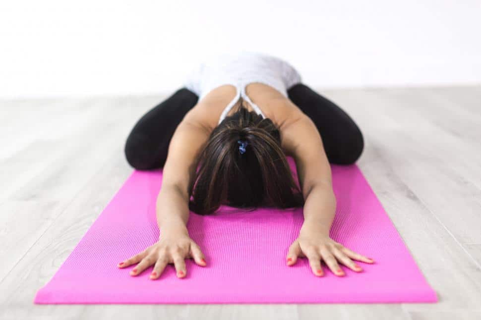 A yogi performing the Child's pose on the yoga mat