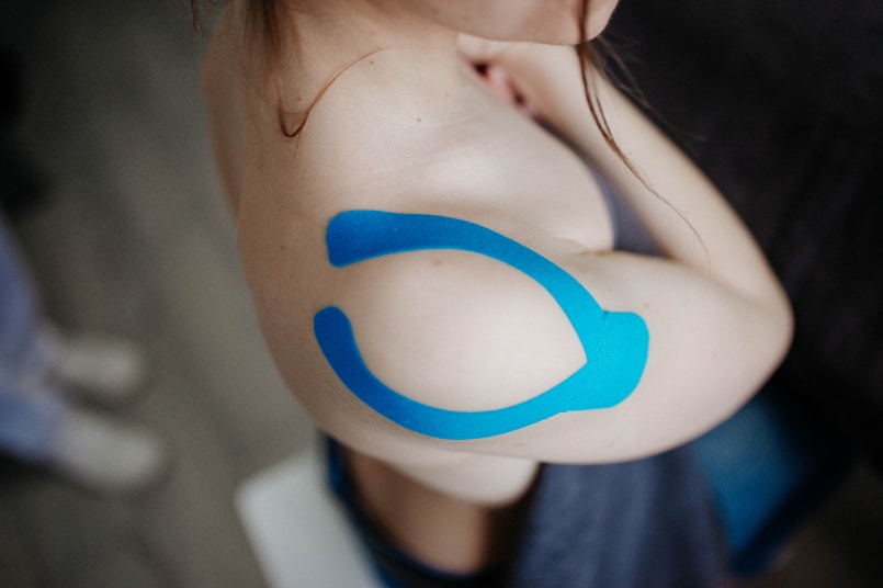 Blue kinesiology tape on shoulder