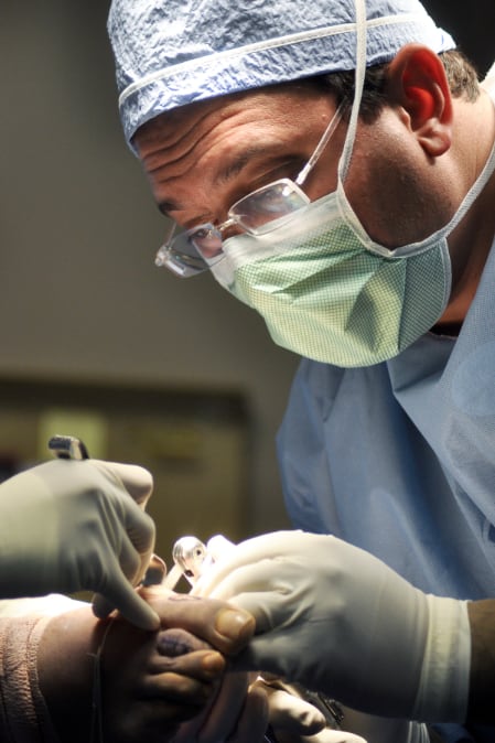 Podiatrist performing bunion surgery