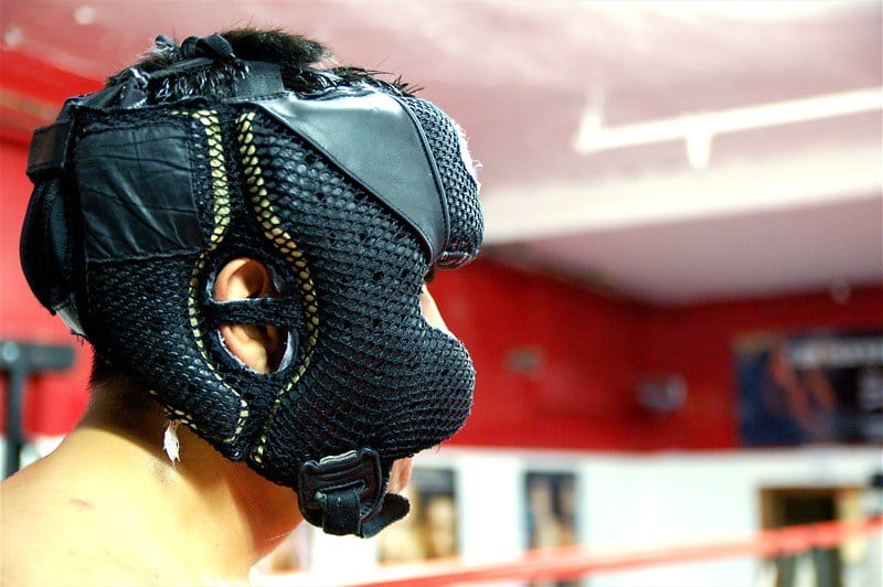 A boxer wearing black headgear during a training session.