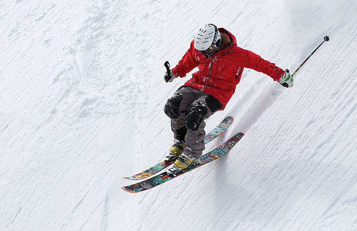 A man skiing on a snowy slope.
