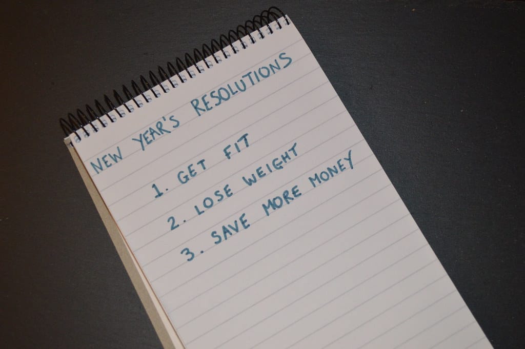 A list of New Year’s fitness resolutions on a notepad.