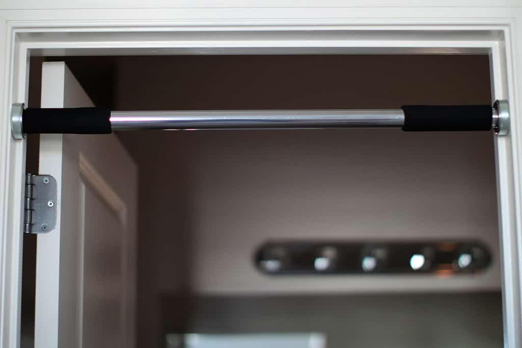 Home door frame with installed chin-up pull-up bar.